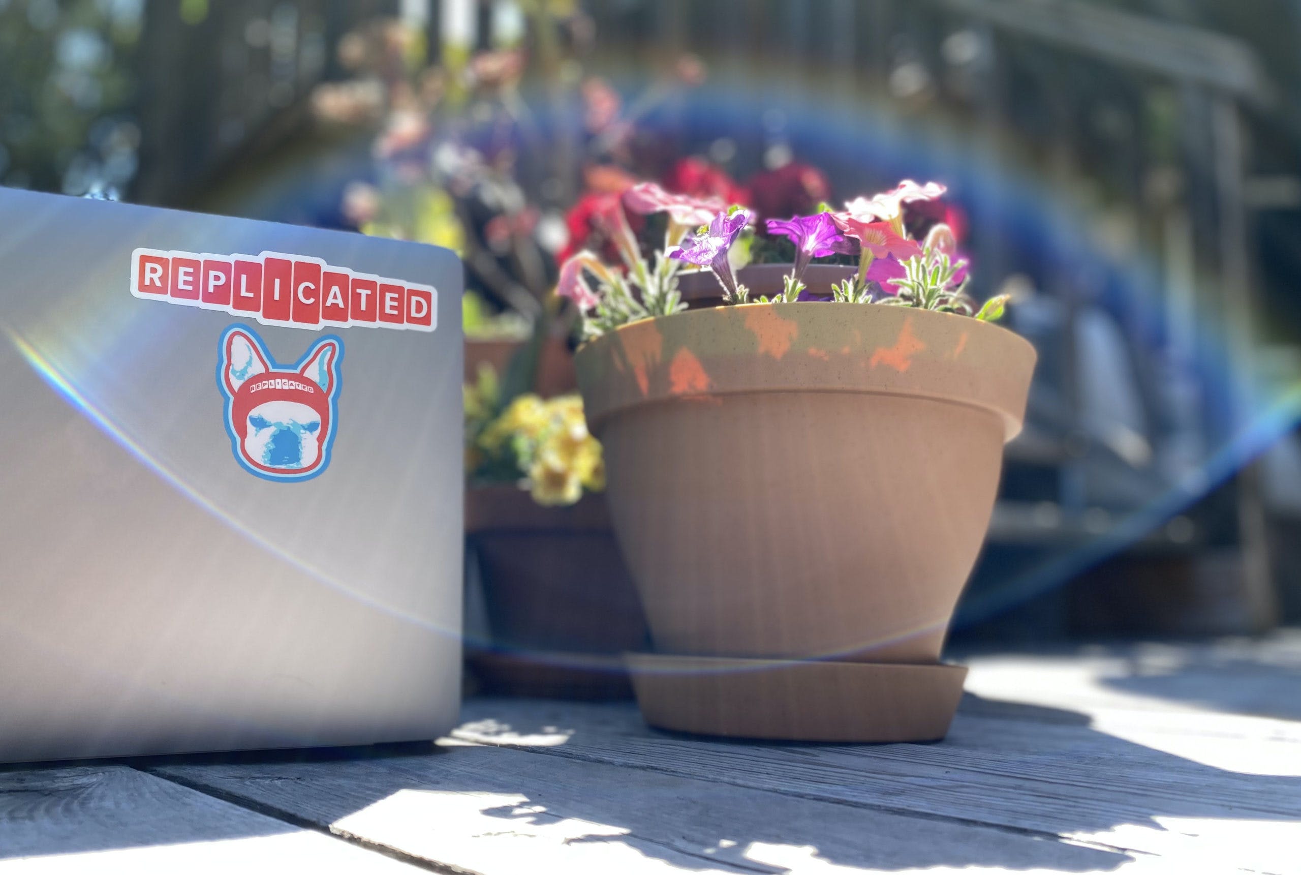 David's Desk with a laptop, replicated logo, out in the sunshine